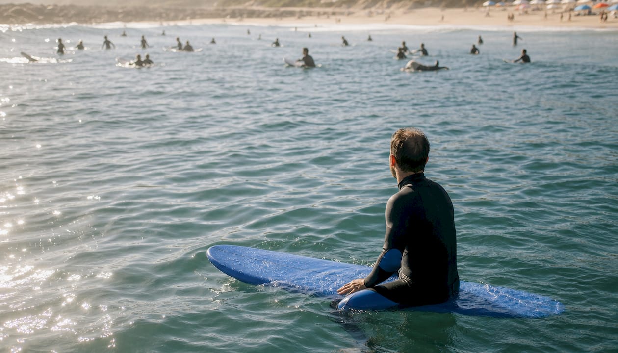Surfer observing lineup for etiquette cues