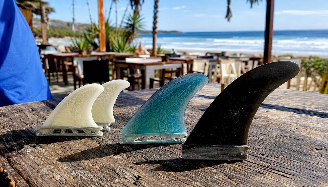Close-up of surfboard fins showing shape variety