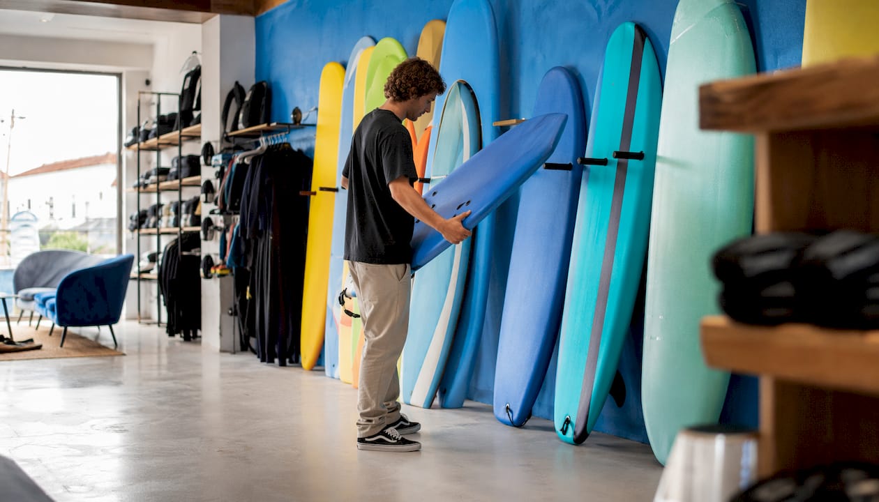 Variety of foam surfboards in surf shop