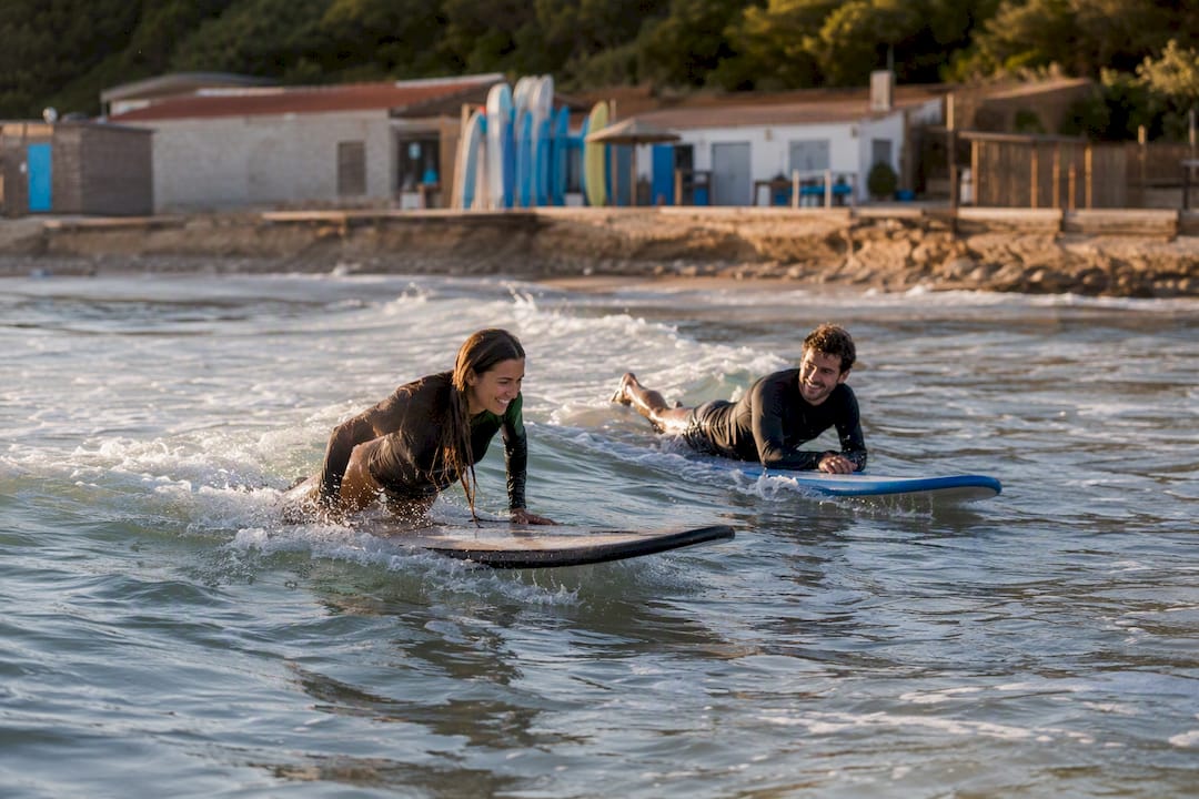 Couple surfing together in whitewater waves