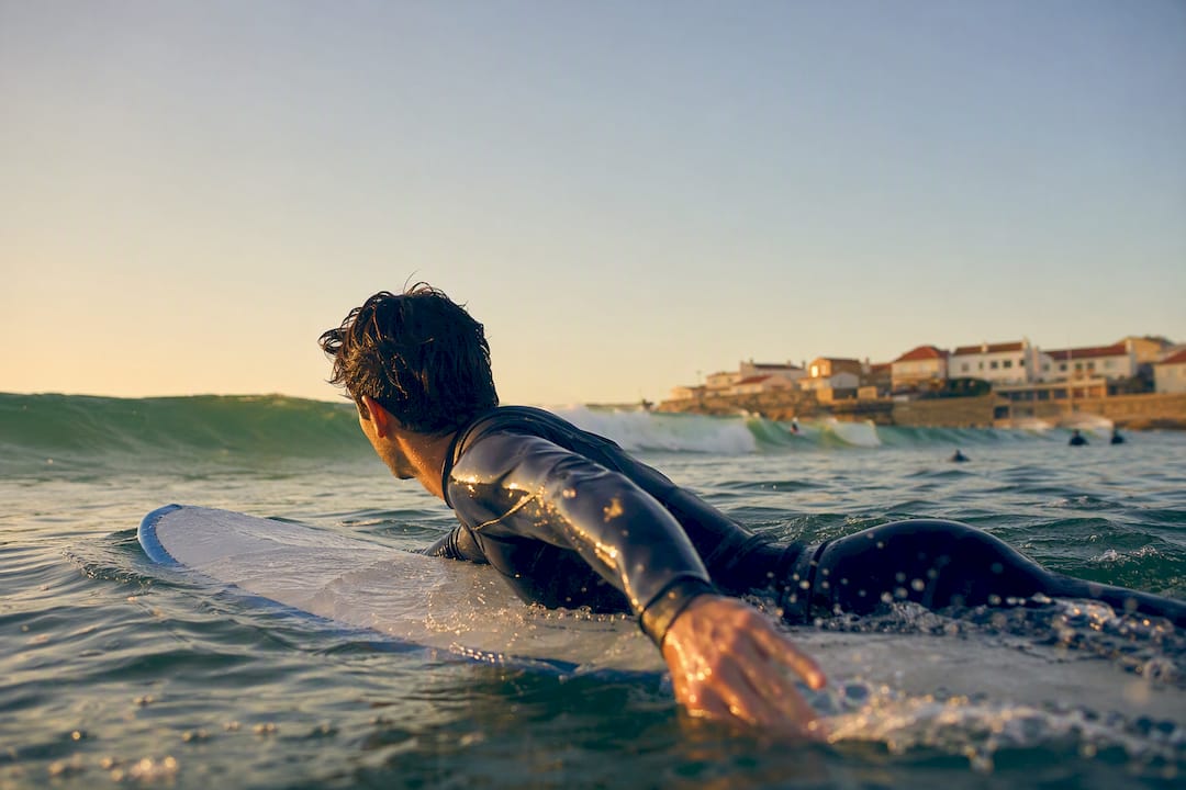 Beginner surfer paddling on wave