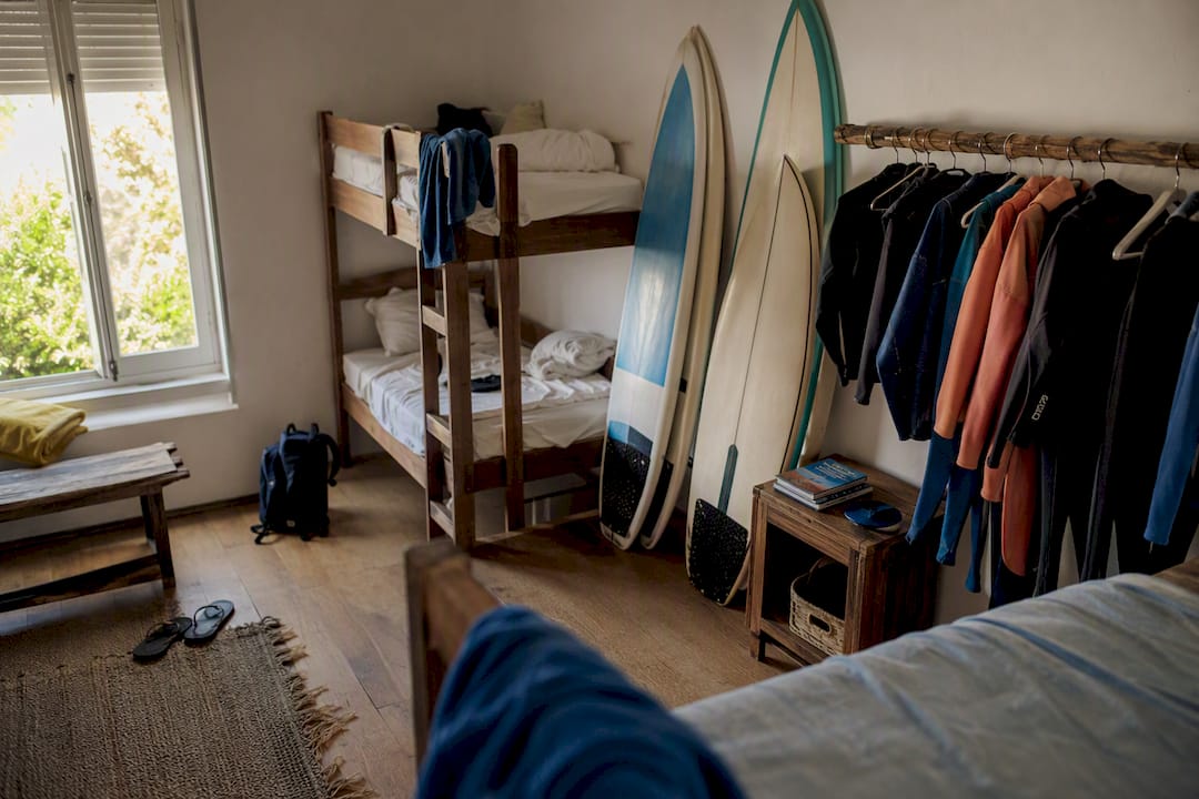 Surf camp dorm room with surf gear