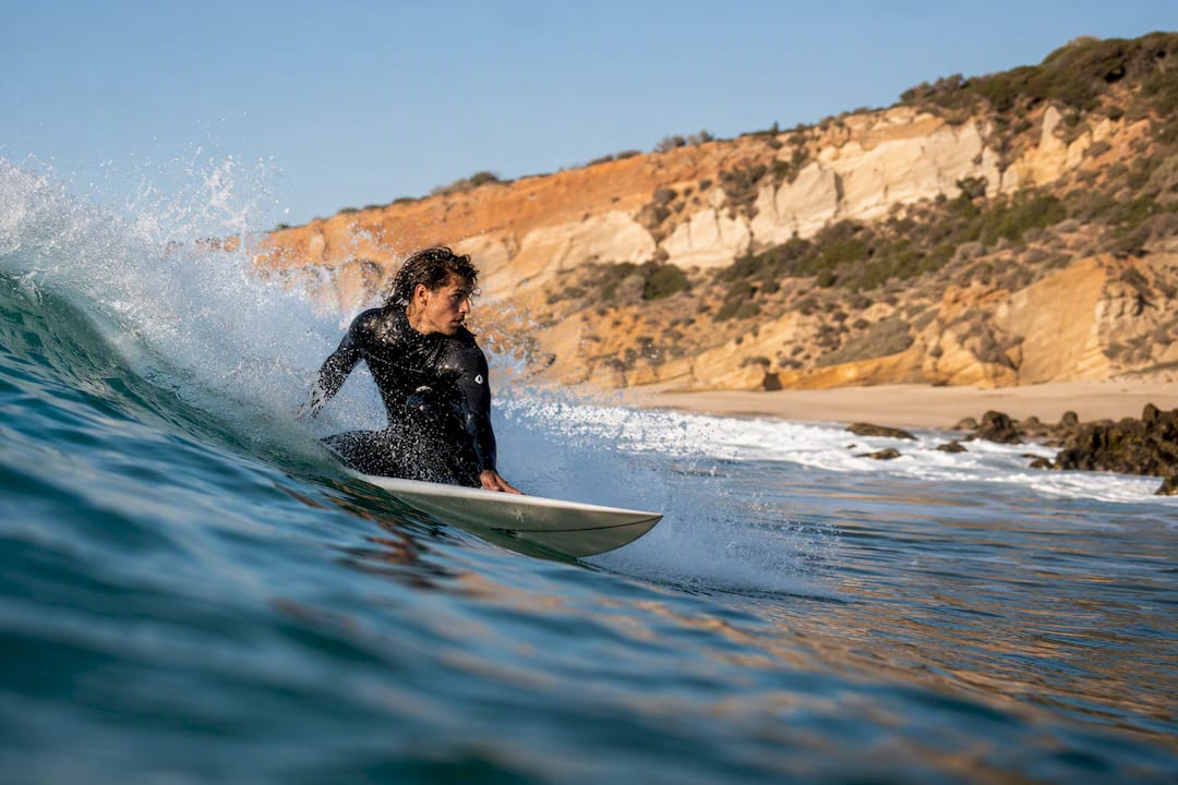 Surfer bottom turning with fin spray