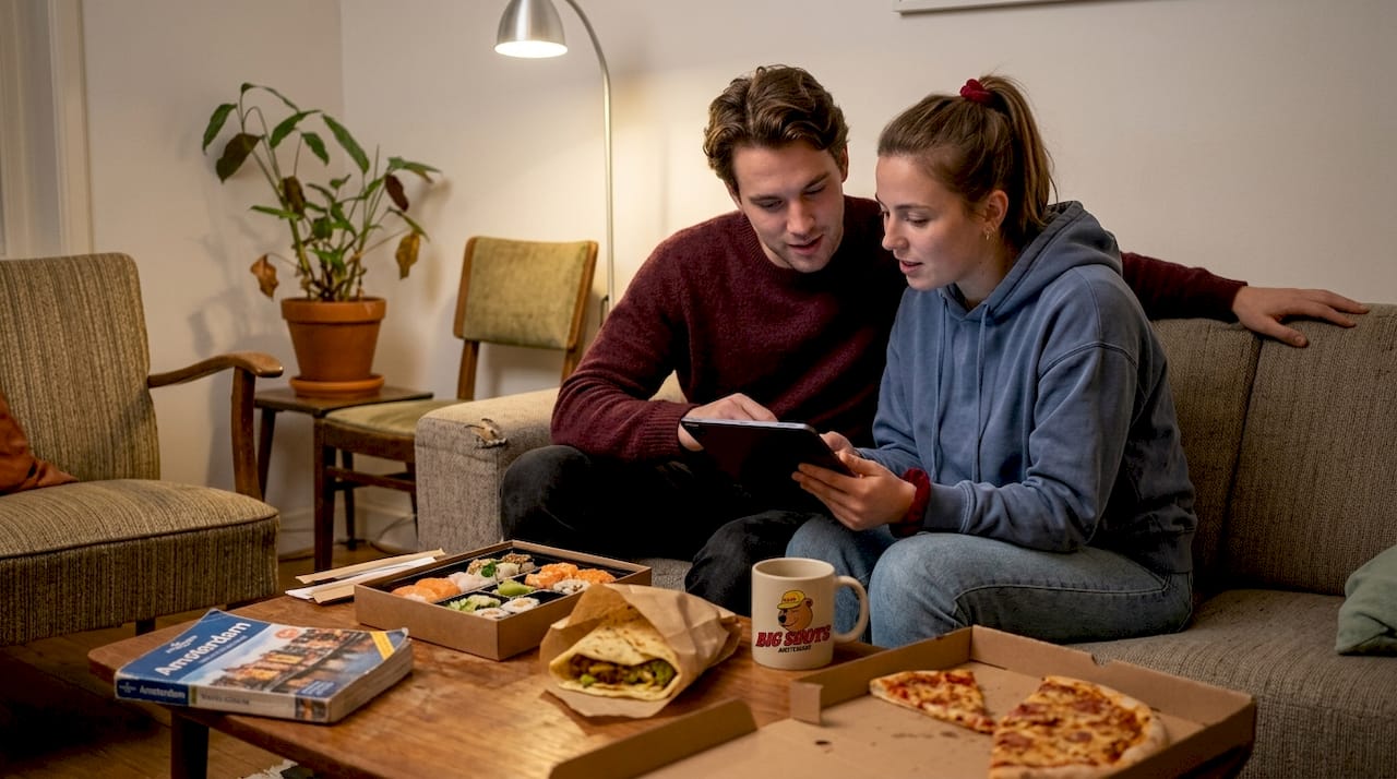 Couple browsing Amsterdam takeout options