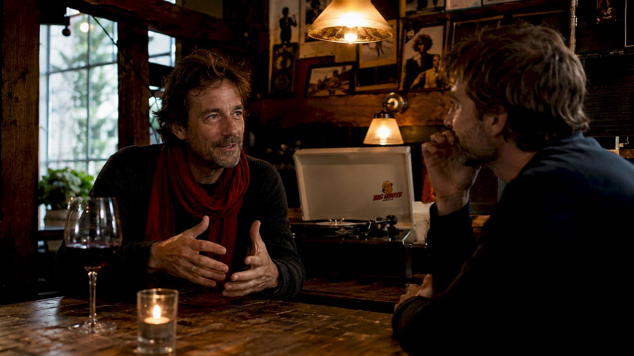 Couple conversing in intimate Amsterdam listening bar