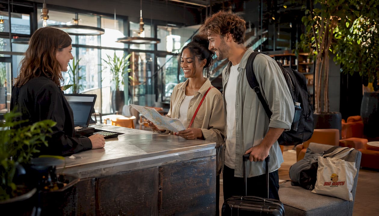 Hotel lobby with couple checking in near district