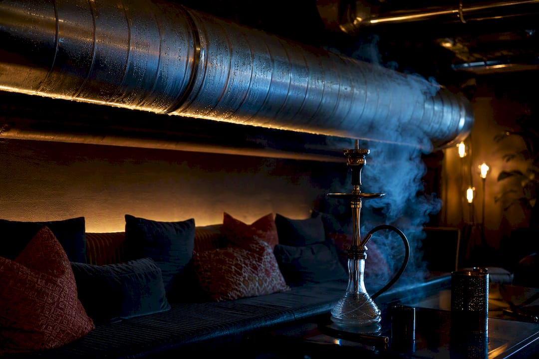 Ventilation duct near lit shisha table