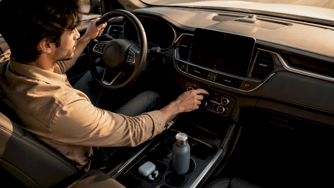 Driver adjusting car ventilation settings