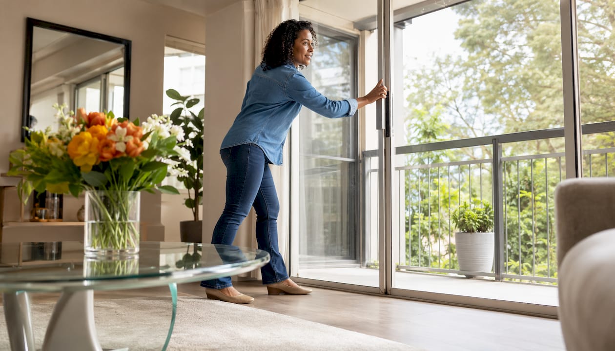 Agent opening windows to freshen model home air