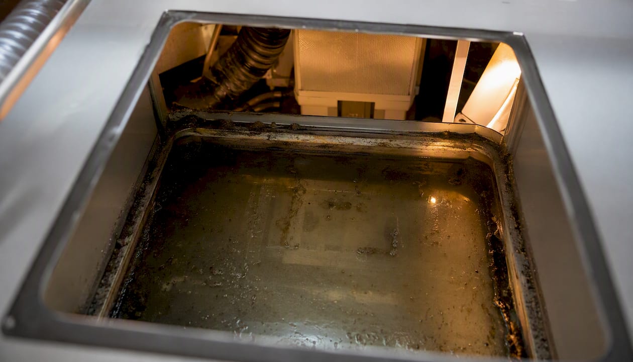 HVAC drip pan with standing water and ductwork