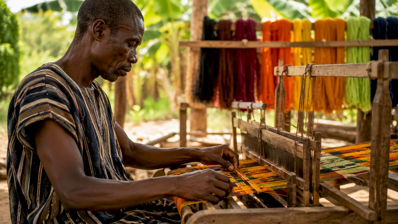 Artisan weaving Kente cloth on loom