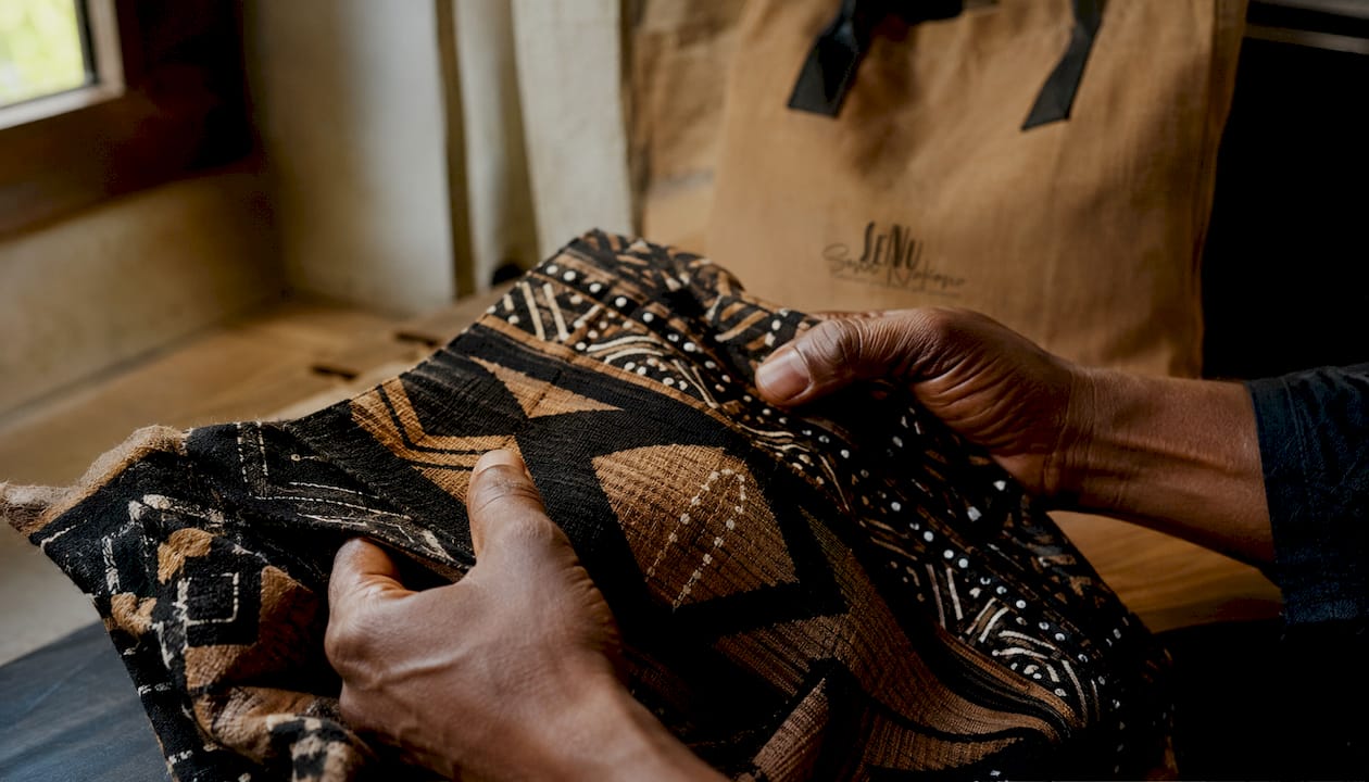 Close-up of hands inspecting fabric weave pattern
