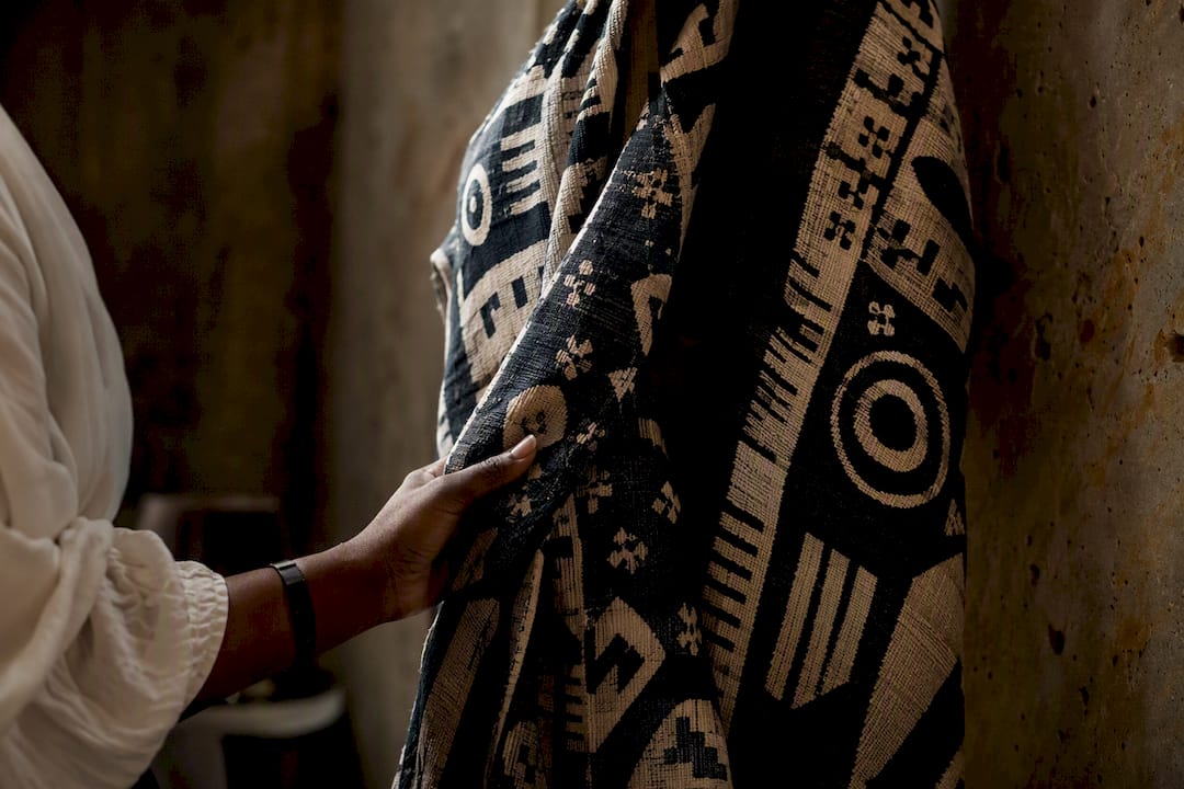 Hand touching West African fashion textile detail