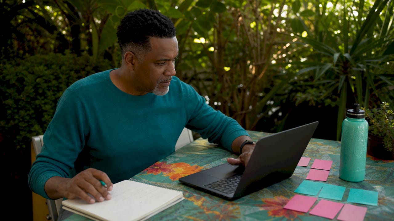 Hands scrolling laptop during virtual awards