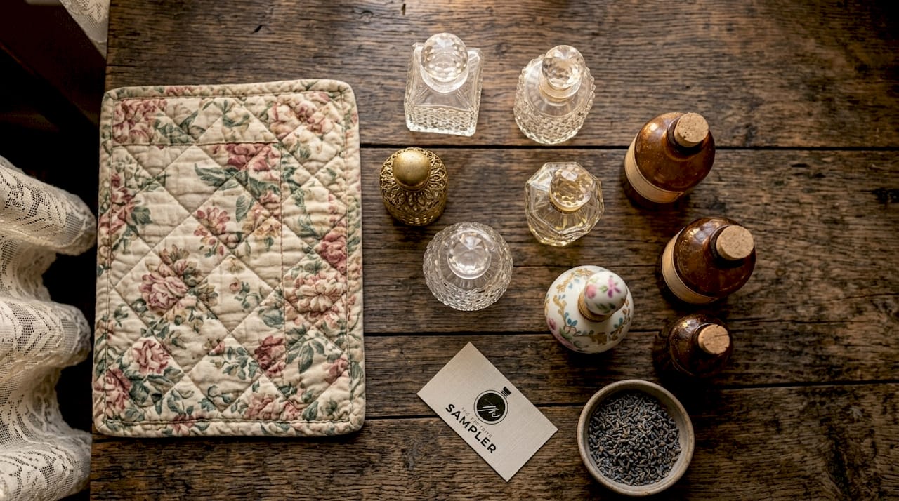 Assorted fragrance bottles on wooden desk