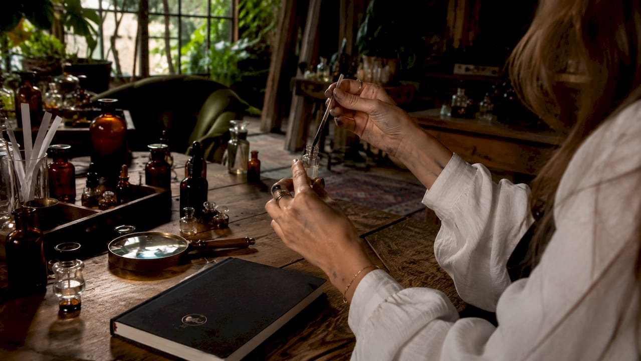 Perfumer testing leather fragrance vial with scent strip