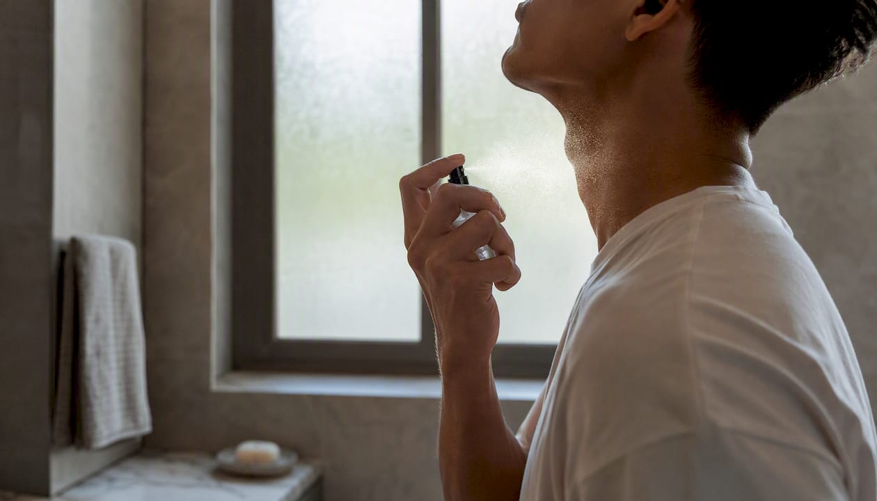 Applying fragrance spray on wrist pulse point