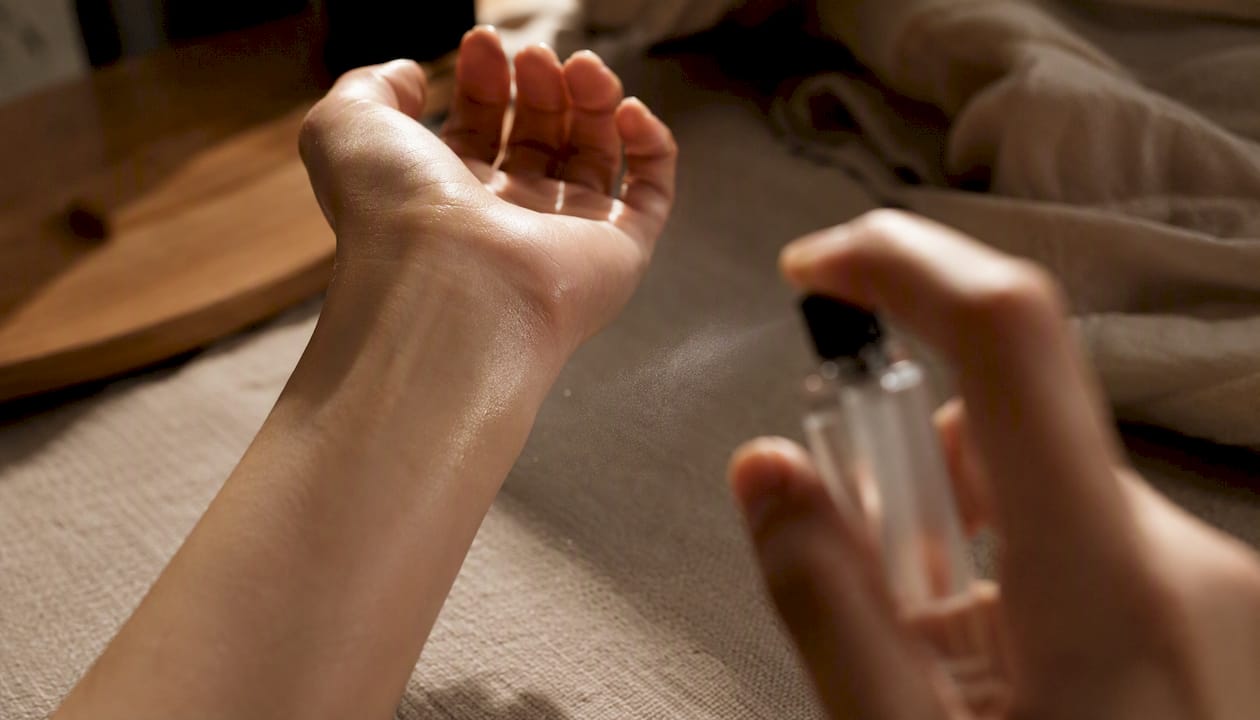 Applying perfume on moisturized wrist