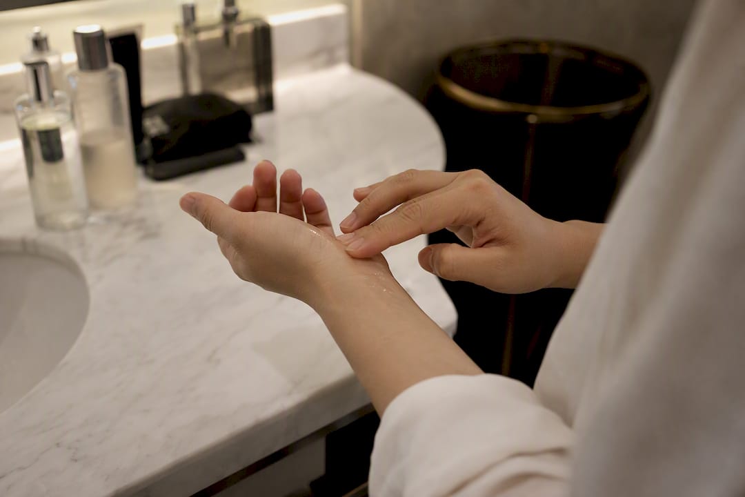Dabbing fragrance oil on inner wrist