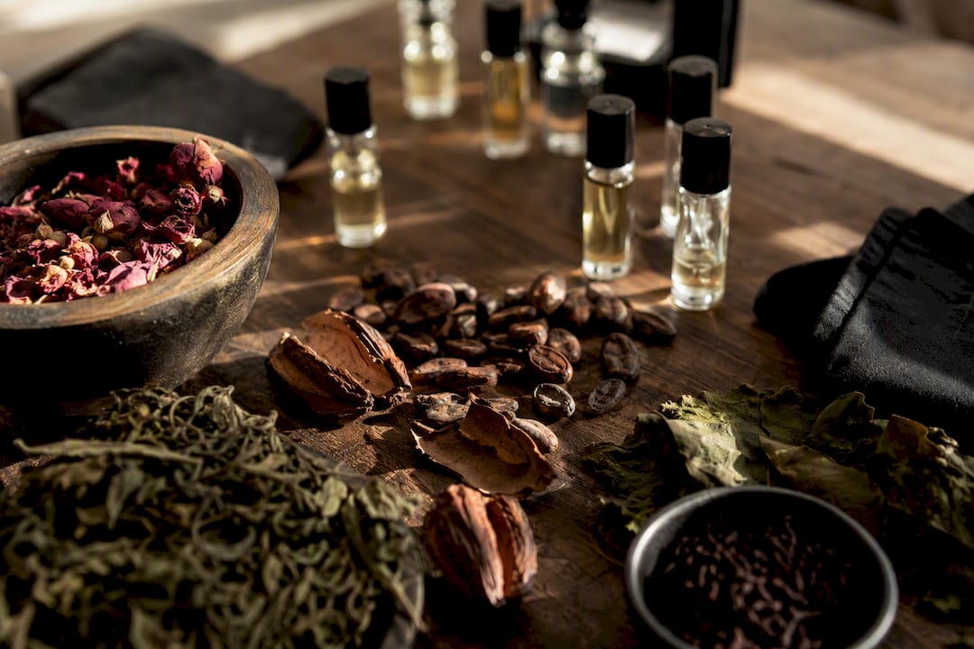 Dried botanicals and perfume decants representing patchouli varieties