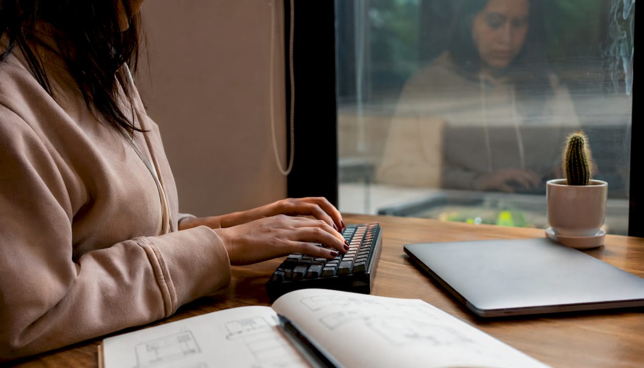 Developer hands typing technical planning notes
