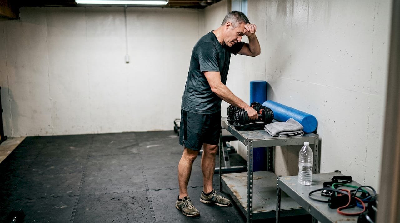Home gym with dumbbells towel and mat