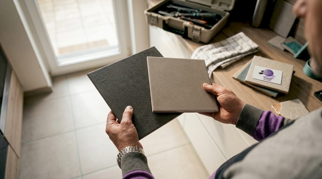 Hands comparing porcelain stoneware tiles