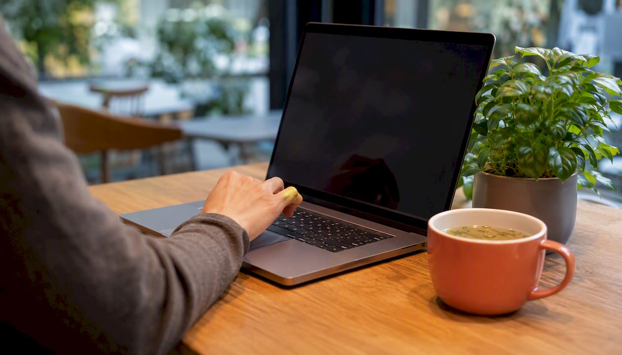 Hand clicking browser timer on laptop keyboard