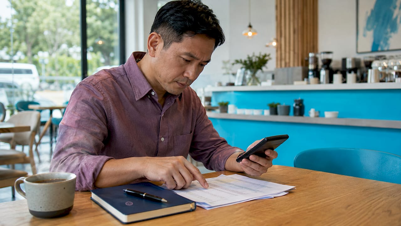 Hands calculating office rental costs at desk