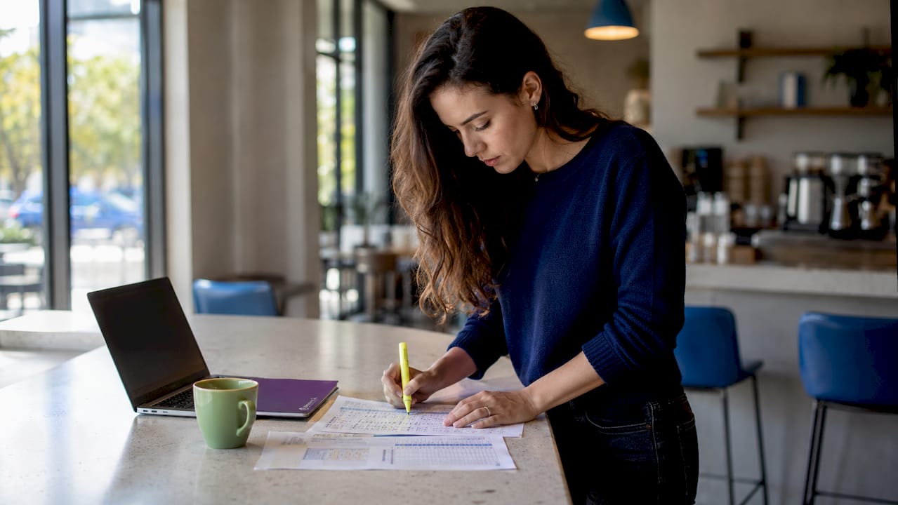 Analyst comparing occupancy cost spreadsheets overhead