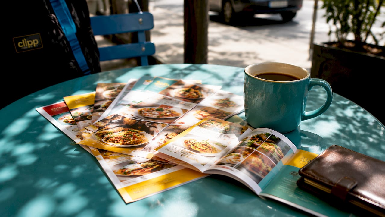 Dining table with restaurant deal flyers and app
