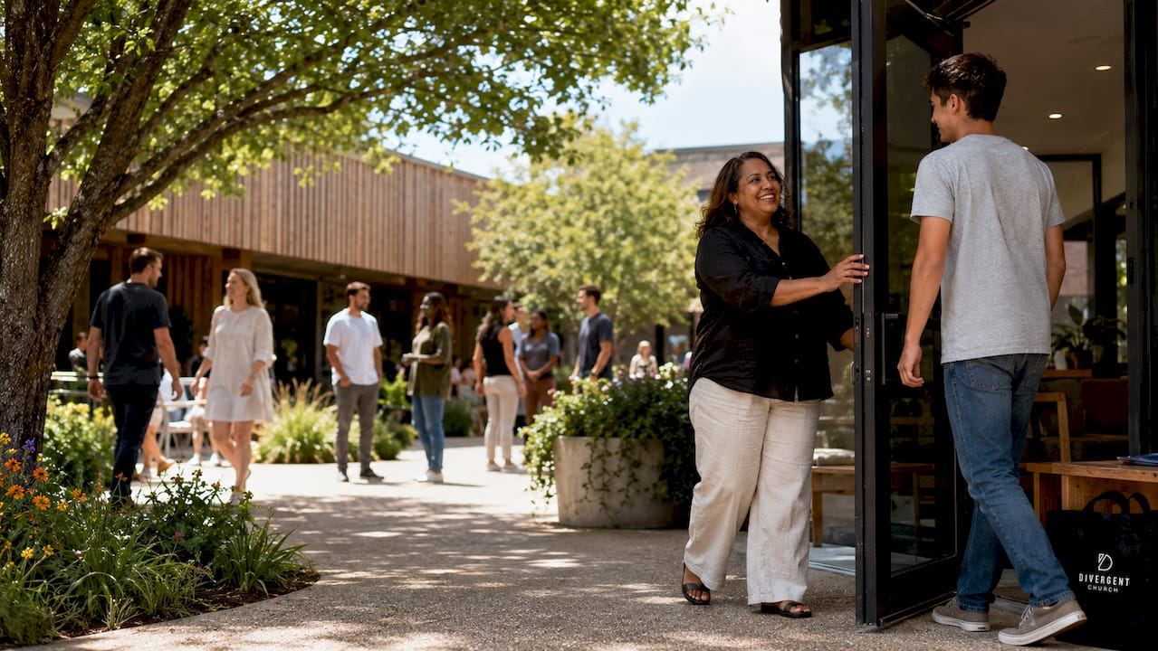 Diverse people entering a welcoming church foyer