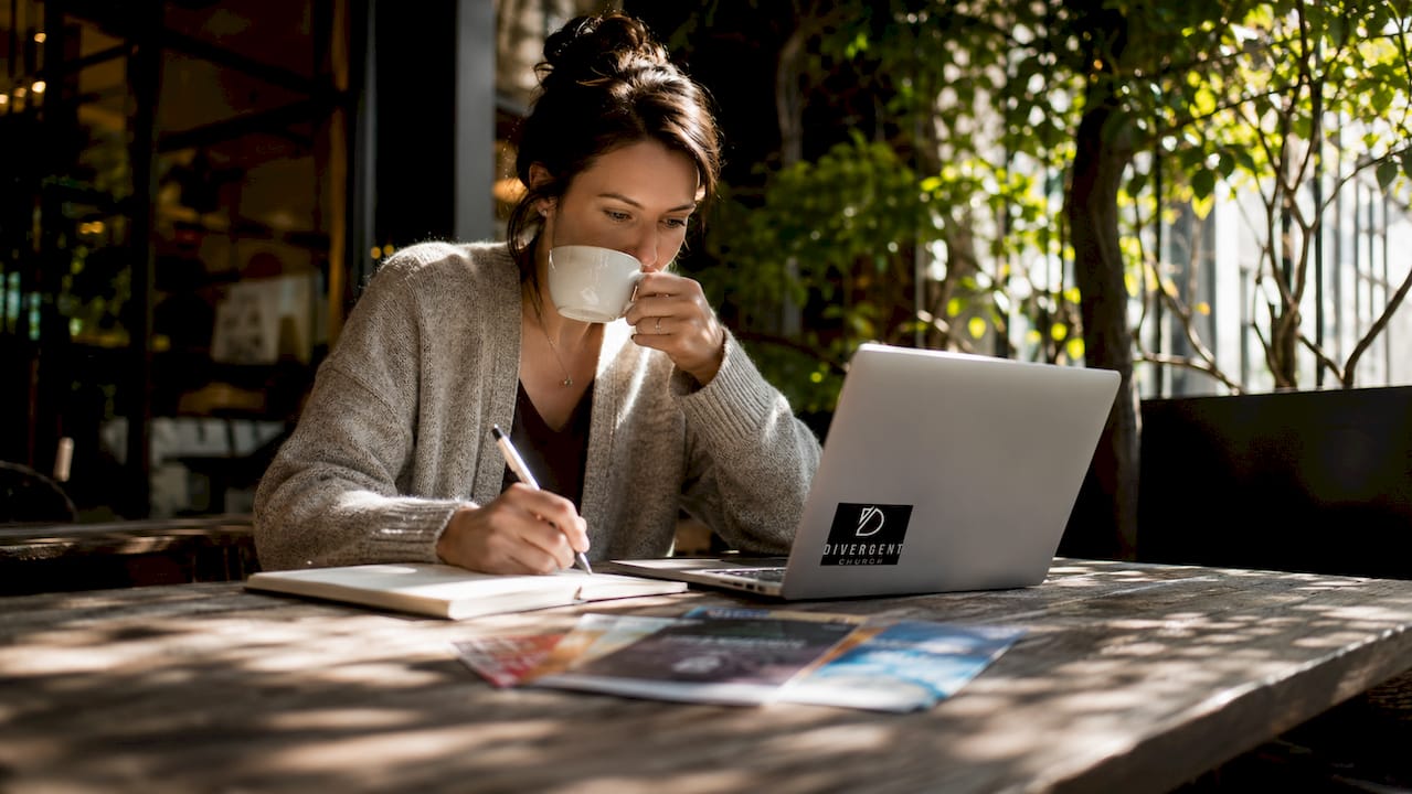 Woman researching churches at home table