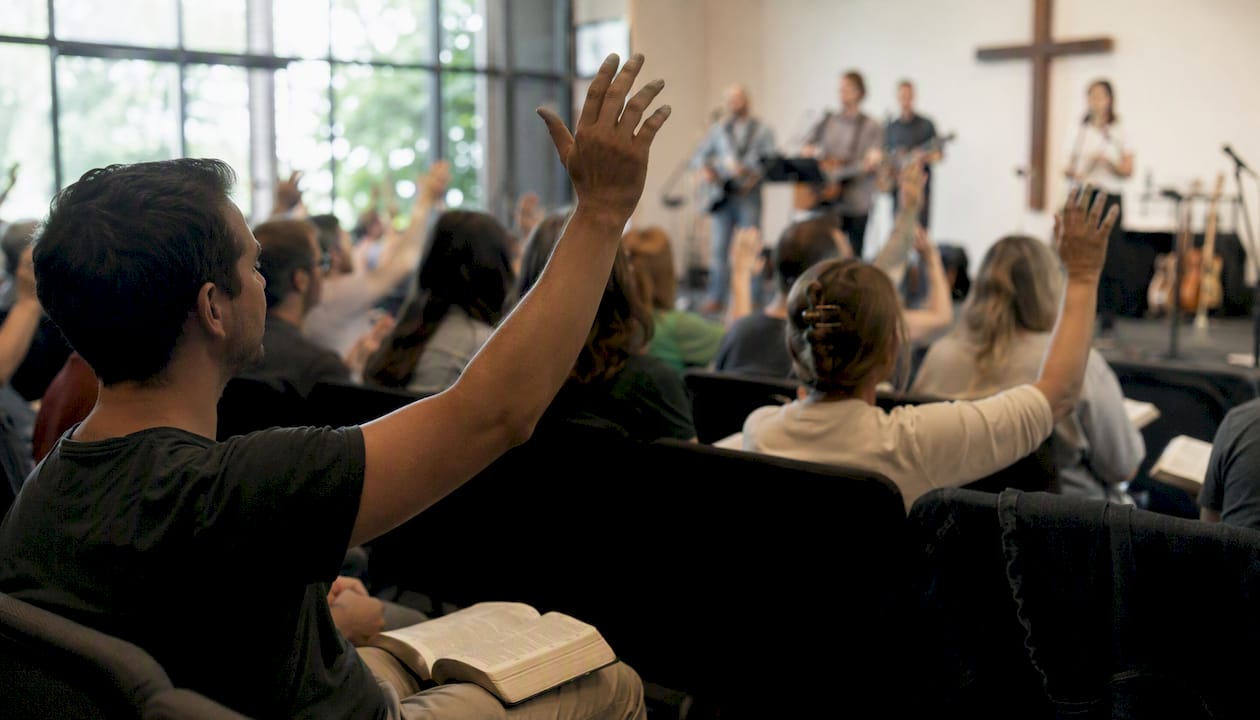 Modern church worship scene with raised hands