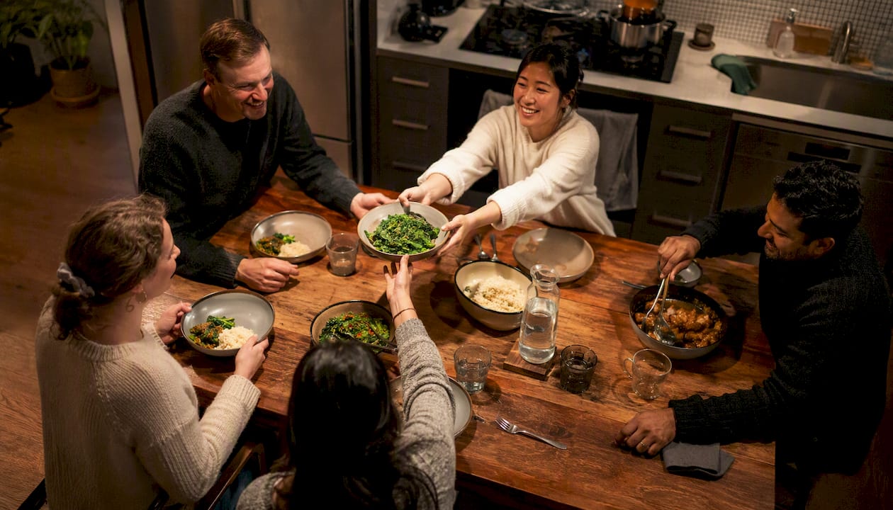 Small group sharing meal in home