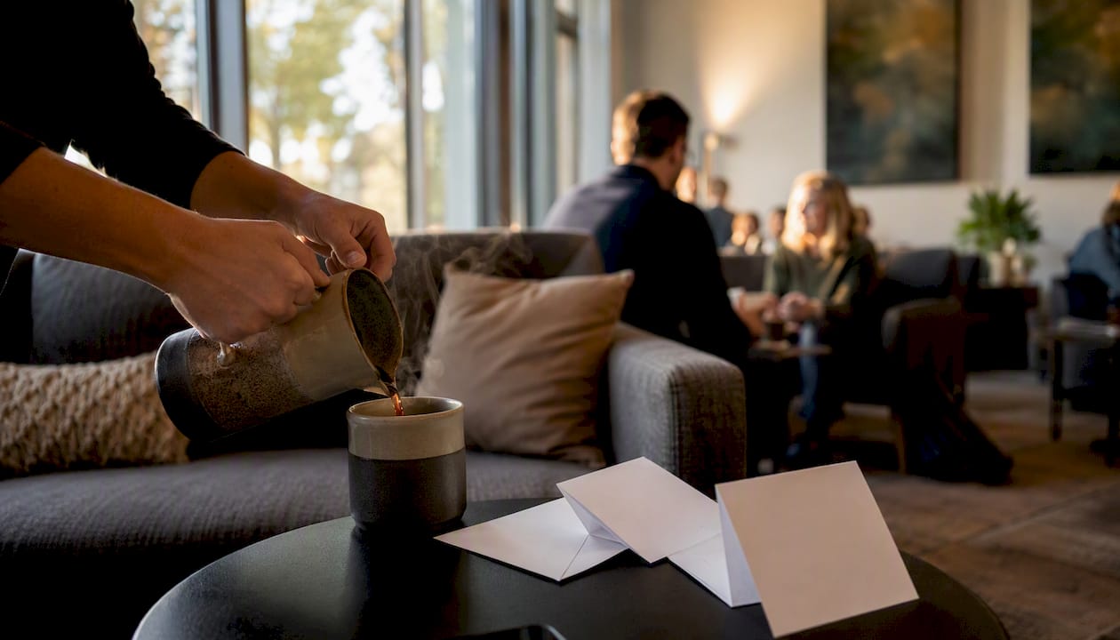 Welcoming hands offering coffee at church foyer