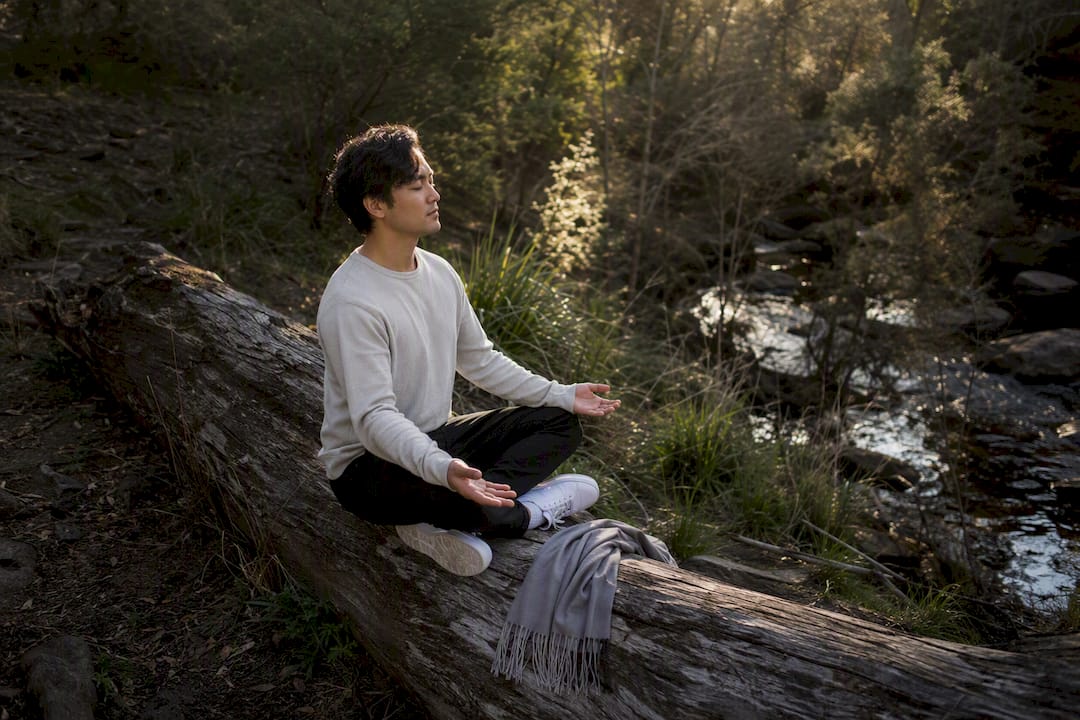 Person in thoughtful meditation outdoors