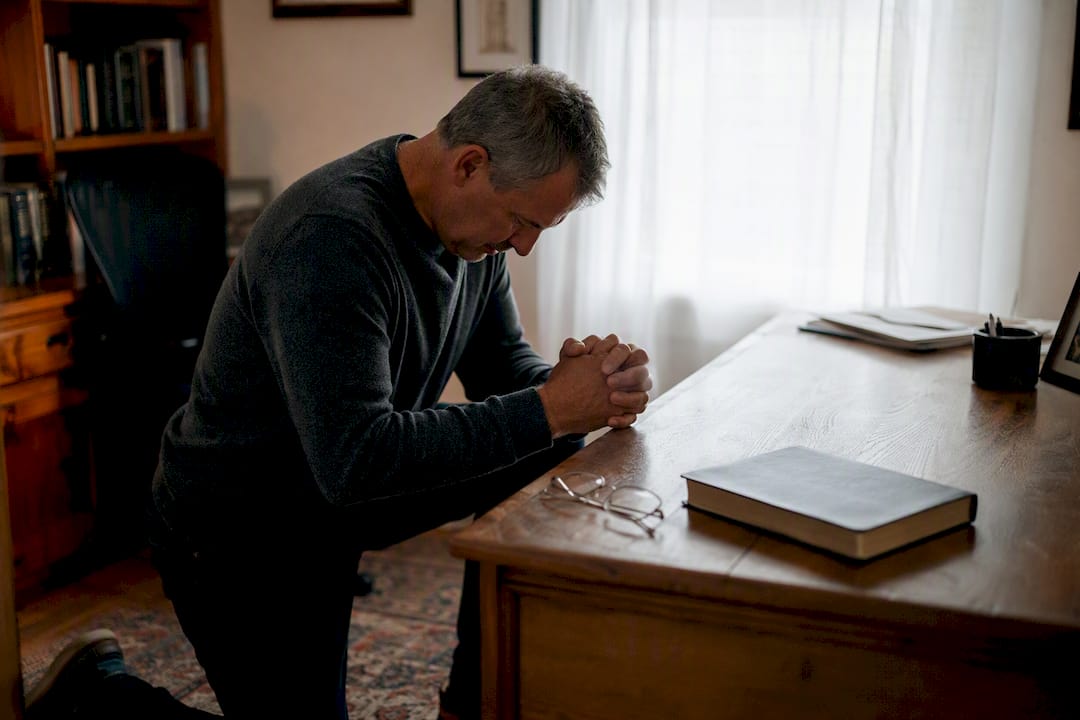 Pastor praying alone in church office