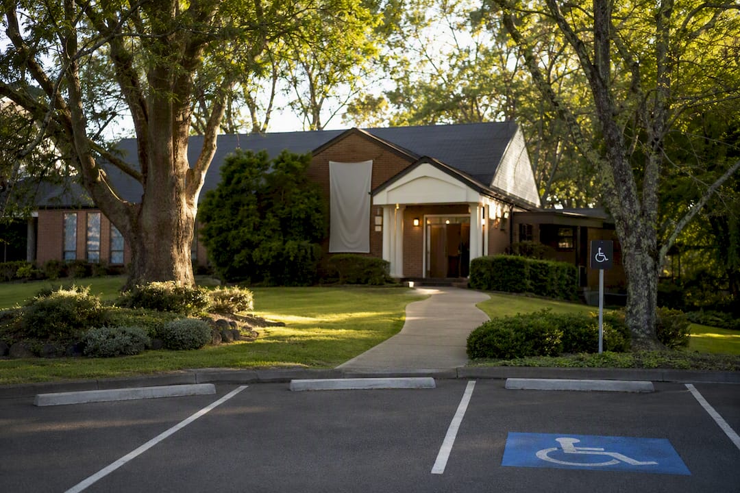 Clear church entrance with family parking spot