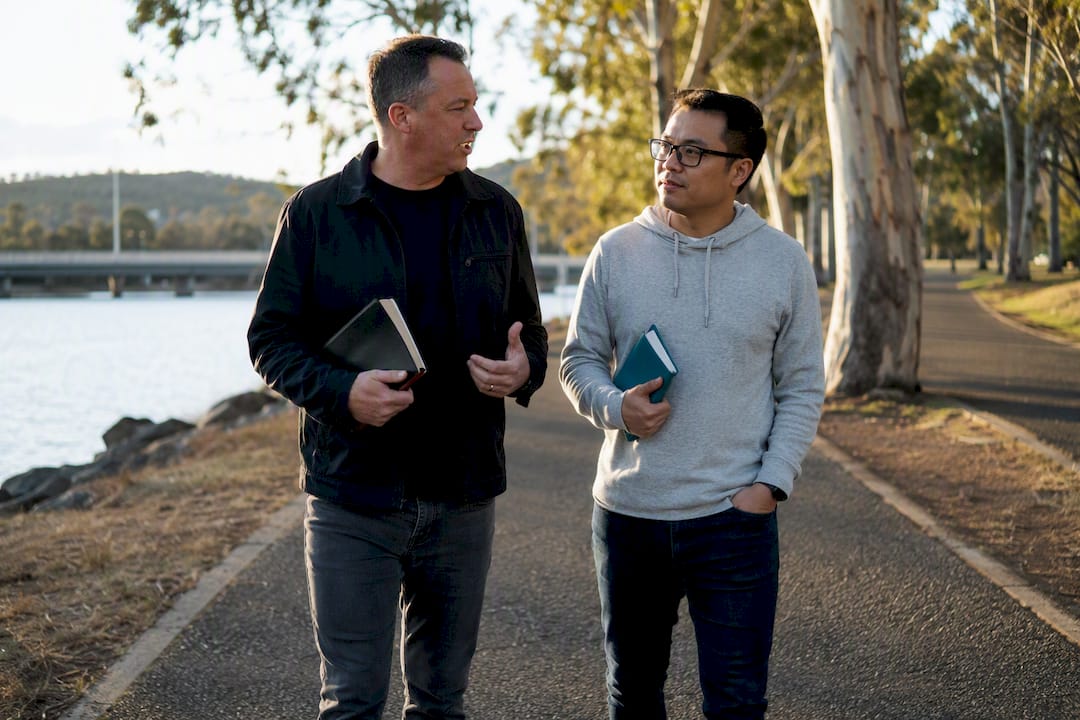 Two Christians walking and talking outdoors