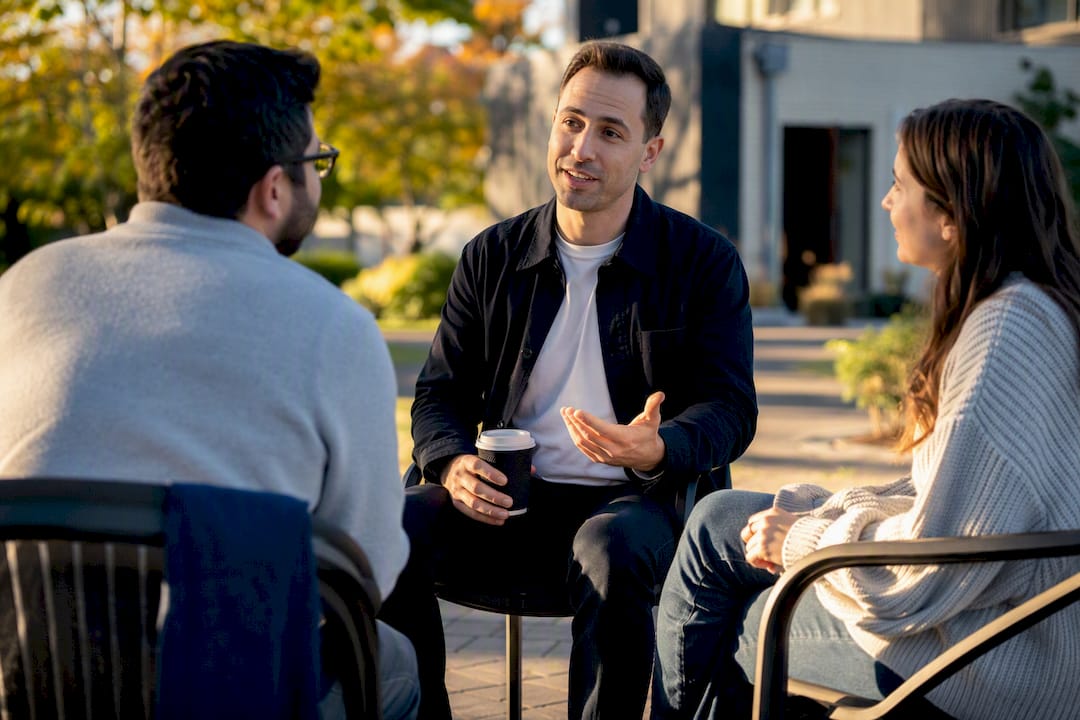 Newcomer talking with church members outdoors