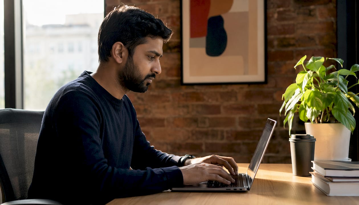 Developer writing ECS Task Definitions at desk