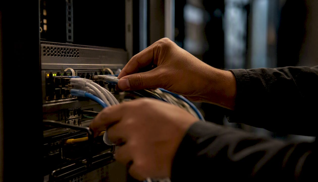 Hands configuring network switch in data center