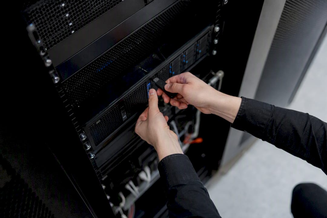Hands connecting backup drive to server