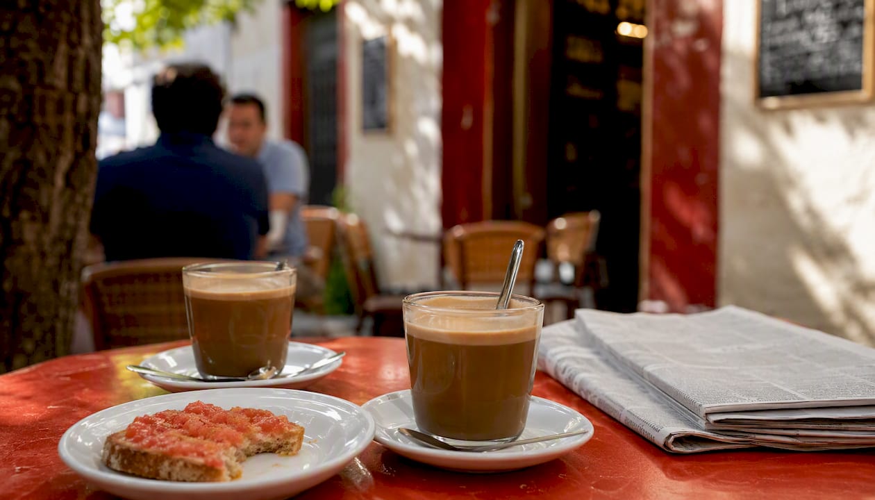 Mid-morning café table with coffee and tostada