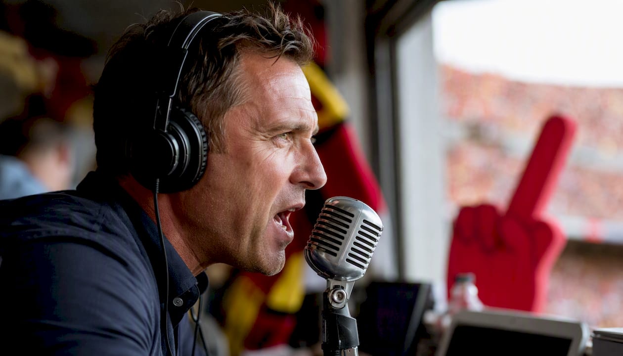 Football commentator speaking into microphone