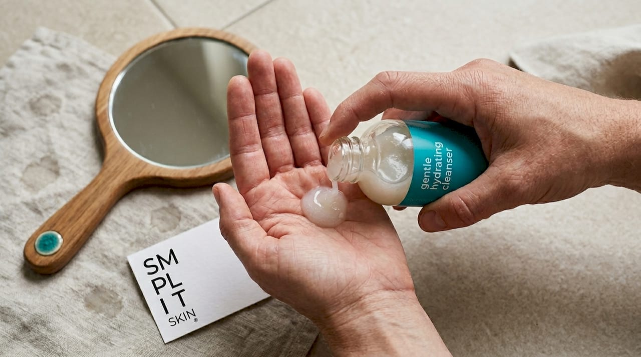 Hands dispensing hydrating cleanser in studio