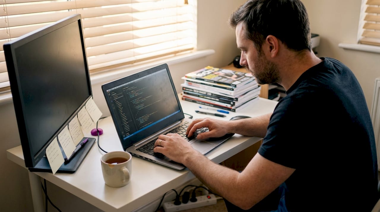 Developer refactoring modular code at home desk