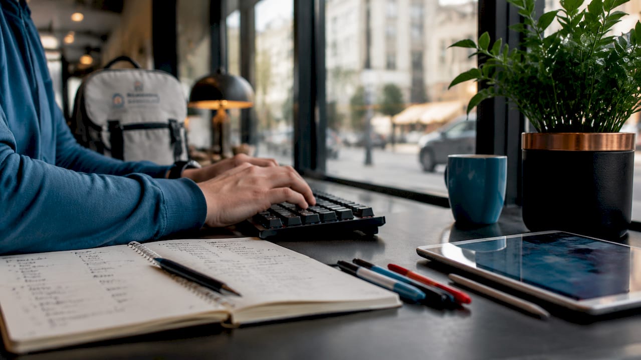 hands typing seo content at home workspace