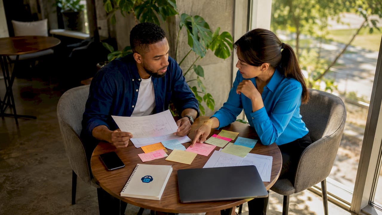 two developers discussing website design plans